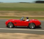 A red Cobra speeds along the West Wyalong disused runway, the fields in the background are out of focus suggesting how fast the vehicle is moving.
